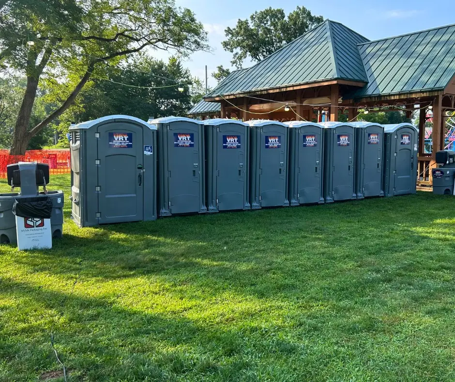 Row of porta potties set up for a large outdoor event by VRT Enterprises